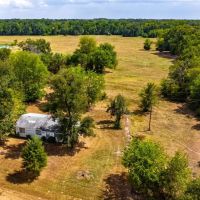 Scenic 87 acres with rolling hills part-wooded pond images 2